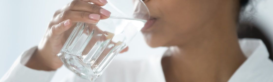 Closeup image woman holding glass drinking still water