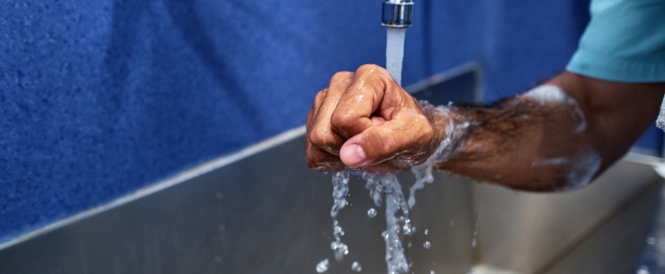 surgeon washing hands with soap and water