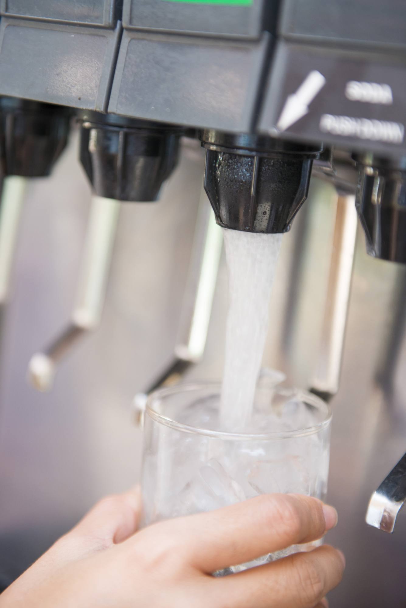 Pressing soft drink from machine, beverage