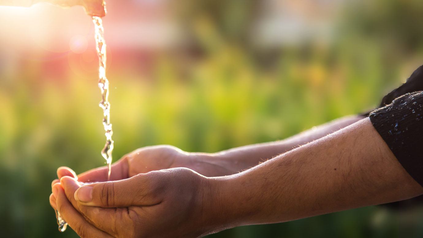 Child's Hands Under Water Tap