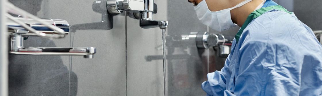 female surgeon washing hands