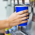 hand of woman serving beverage of cooler